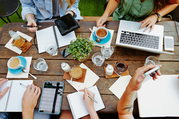 Young entrepreneurs having a creative business meeting in a cafe
