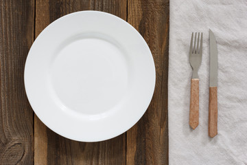 Empty Plate And Cutlery On The Wooden Table 