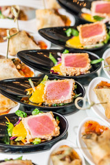Gourmet appetizers: caviar, venison, tuna and salmon.