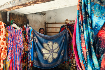 Young woman trying on dress in African store