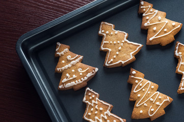 Fototapeta na wymiar top view of christmas gingerbreads on baking tray