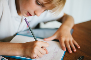 A tween boy doing school work
