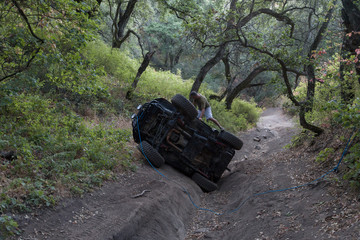 Man on rolled over off road vehicle