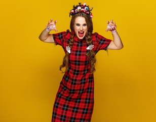 young woman in halloween costume frightening