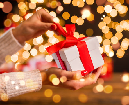 Detail Of Woman Hand Unwrapping Christmas Gift