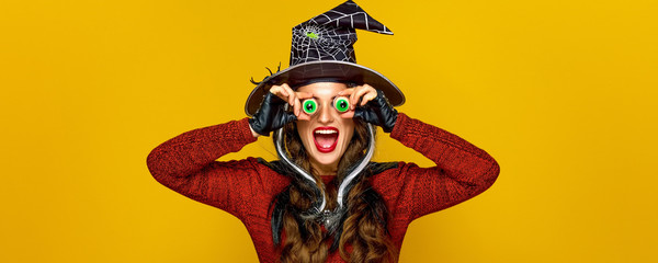 happy modern woman on yellow background having fun time