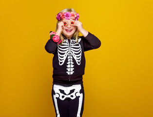 cheerful child isolated on yellow background having fun time