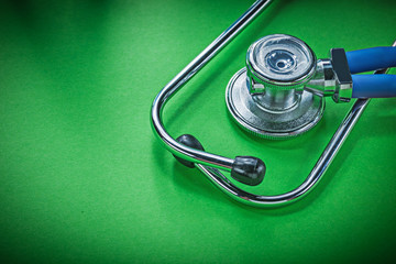 Medical stethoscope for checkup on green background