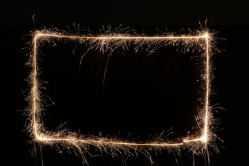 Rectangle border made with sparkler on black background.