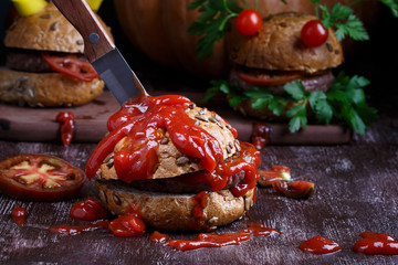 Homemade bloody burger and burger monsters for Halloween celebration.