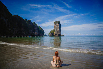 Young fashion woman relax on the beach. Happy island lifestyle. White sand, blue cloudy sky and crystal sea of tropical beach. Vacation at Paradise. Ocean beach relax, travel to Thailand, Krabi
