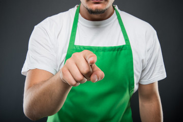 Close-up of supermarket employer pointing camera