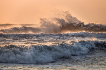 Fototapeta premium Sea waves crashing on a rocky pier, Italy, Tuscany