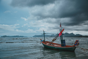 Coastal fishing boats at low tide in summer of Thailand