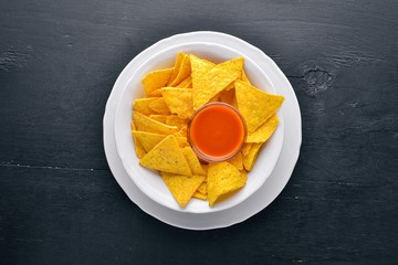 Snack for beer. Chips On a wooden background. Top view. Free space for your text.