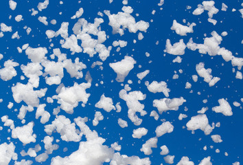 White foam against the blue sky as background