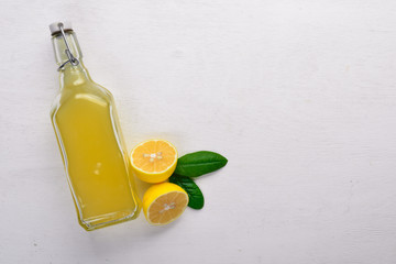 Fresh Lemons and Lemon Juice. On a wooden background. Top view. Free space for your text.