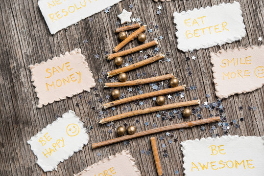 New Year's resolutions and Christmas tree on vinatege wooden backgroun