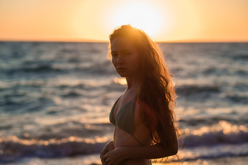 Fototapeta na wymiar young slim beautiful woman on sunset beach, playful, dancing, running, bohemian outfit