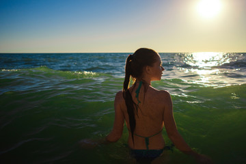 young slim beautiful woman on sunset beach, playful, dancing, running, bohemian outfit