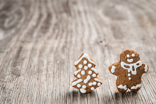 Gingerman and Christmas tree made of gingerbread dough as backgorund