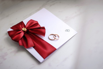 Wedding rings on the wedding invitation