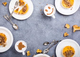 Thanksgiving day concept with homemade pumpkin tartlet, mini pie, on gray stone background. Healthy autumn food flat lay, copy space, top view.