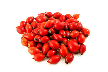 A pile of dog rose berries close up isolated on white background.