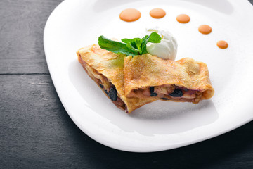 Apple Strudel with Ice Cream. On a wooden background. Top view. Free space for your text.
