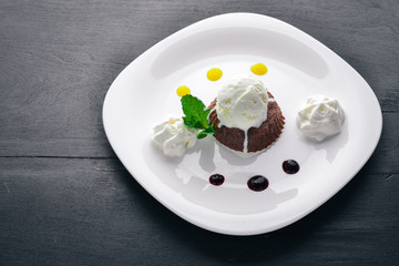 Chocolate Cake Dessert with Ice Cream. On a wooden background. Top view. Free space for your text.