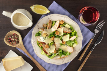 Chicken Caesar salad with wine and ingredients