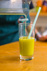 Pouring Detox Fruit Drink in a Glass