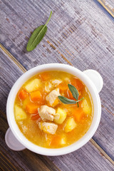 Chicken, butternut, apple ginger and sage stew. Pumpkin and chicken breast soup. View from above, top shot, vertical