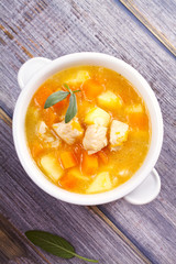 Chicken, butternut, apple ginger and sage stew. Pumpkin and chicken breast soup. View from above, top shot, vertical