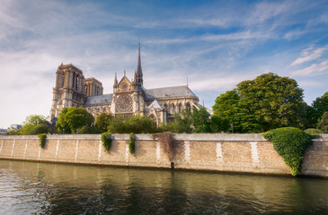 Notre Dame de Paris, France, at daytime. Summer travel background. Scenic cityscape with dramatic sky.