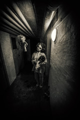 Fototapeta na wymiar Horror movie scene of a scary woman with bloody doll