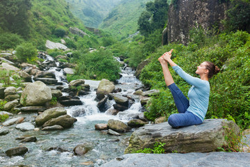 Naklejka na ściany i meble Woman doing Ashtanga Vinyasa Yoga asana outdoors