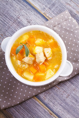 Chicken, butternut, apple ginger and sage stew. Pumpkin and chicken breast soup. View from above, top shot, vertical