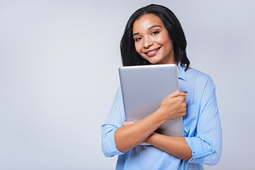 Fototapeta premium Smiling woman pressing laptop to her chest