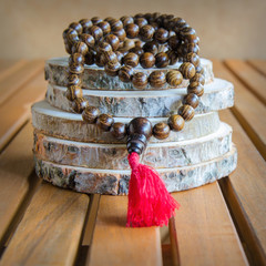 Close up of wood mala beads, traditionally used in prayer and meditation. Essential accessory for...