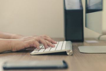 Close up beside hand typing on the keyboard