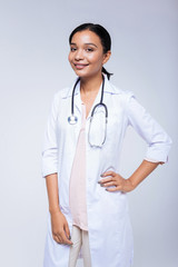 Smiling woman posing in a medical uniform