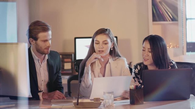   A creative diversity business team with a successful young female leader discussing about a concept.