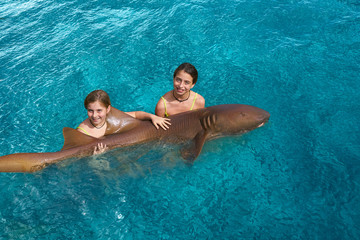 Sister girls hug a Nurse Shark in Riviera Maya