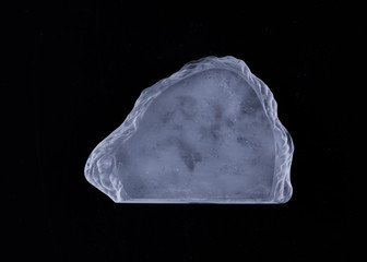 a piece of ice on a black background