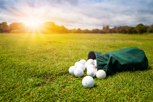 Selective focus Golf Balls for training in  green fabric bag on the golf course in morning.