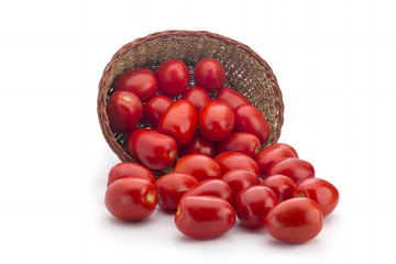 Red tomatoes in a basket on a white background