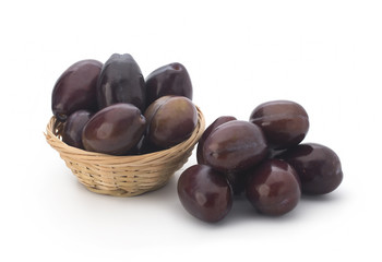 Plums in a basket on a white background