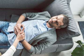 Sad man having session of psychoanalysis