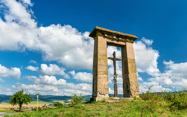 Fototapeta na wymiar Christian cross in a field on the border between Presov and Kosice regions in Slovakia